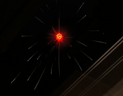 Image of a meteor bearing down from above. The meteor itself has an ouroboros symbol on it.